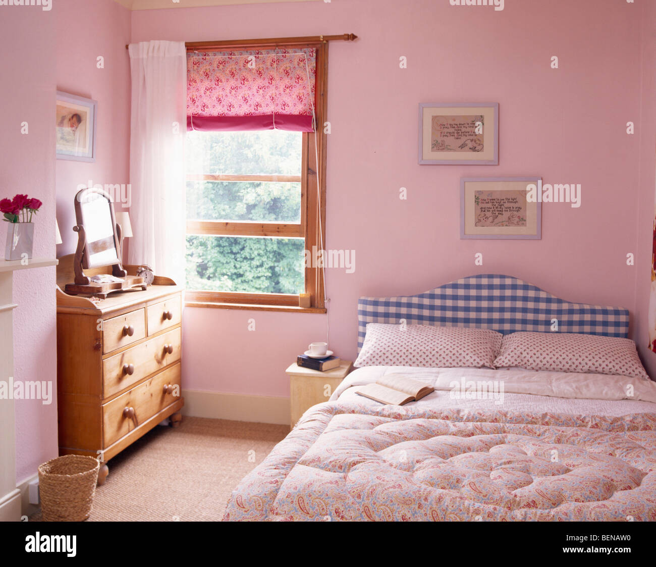 Pink blind and white curtain on window in pastel pink country bedroom
