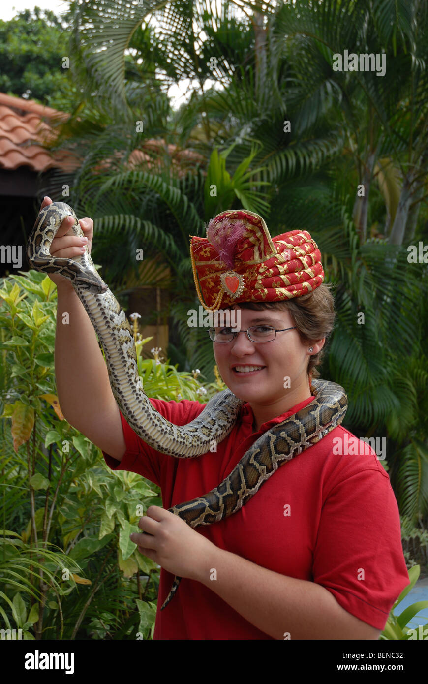 young girl (aged 10) holding a Burmese Python, Sentosa Island ...