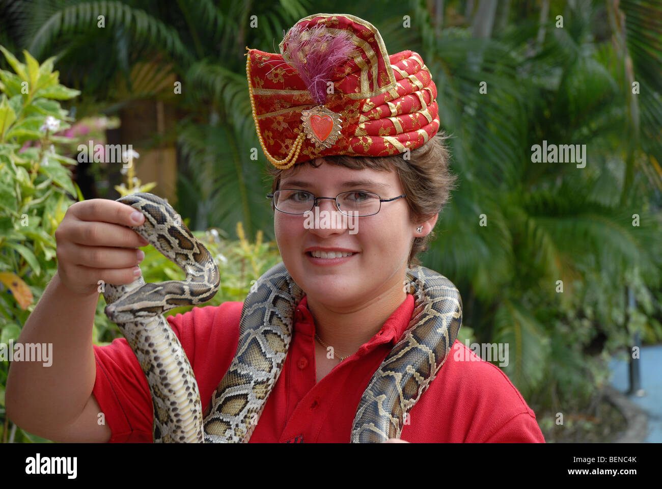 young girl (aged 10) holding a Burmese Python, Sentosa Island ...
