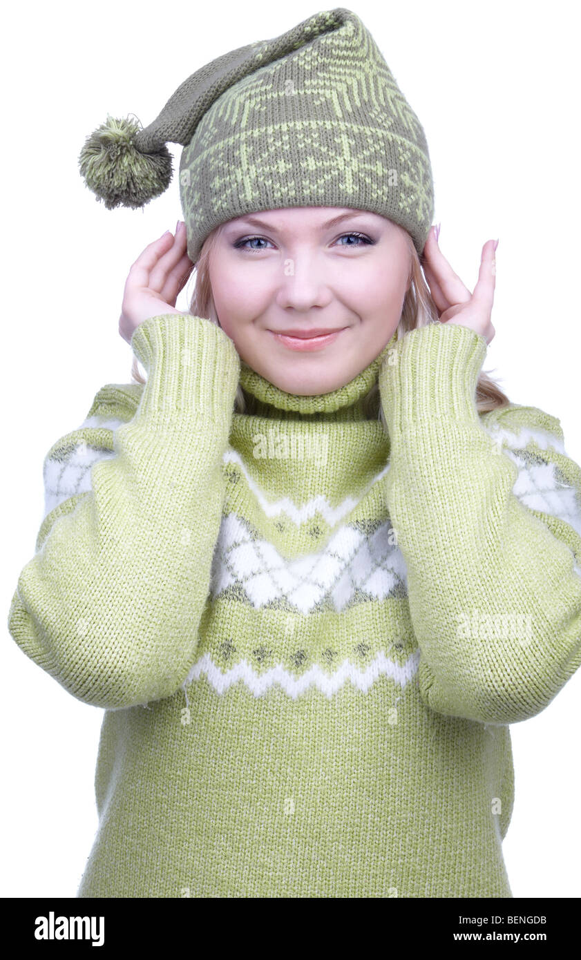 portrait of beautiful slavonic blonde girl in green sweater and winter cap with bob titivating Stock Photo