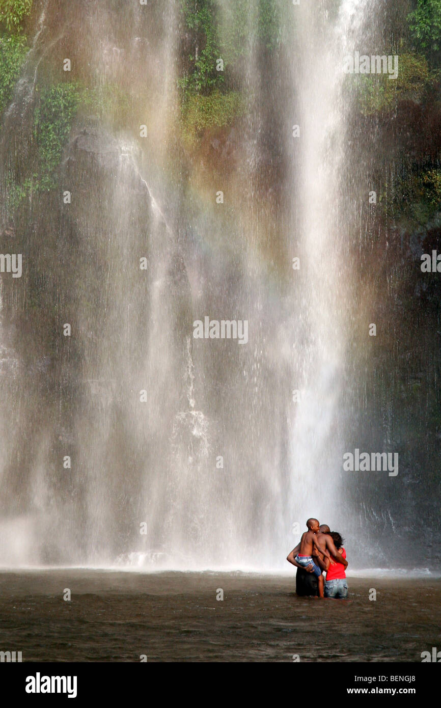 Black family laughing and having fun while bathing under the Wli Waterfall / Wli falls in Ghana, West Africa Stock Photo