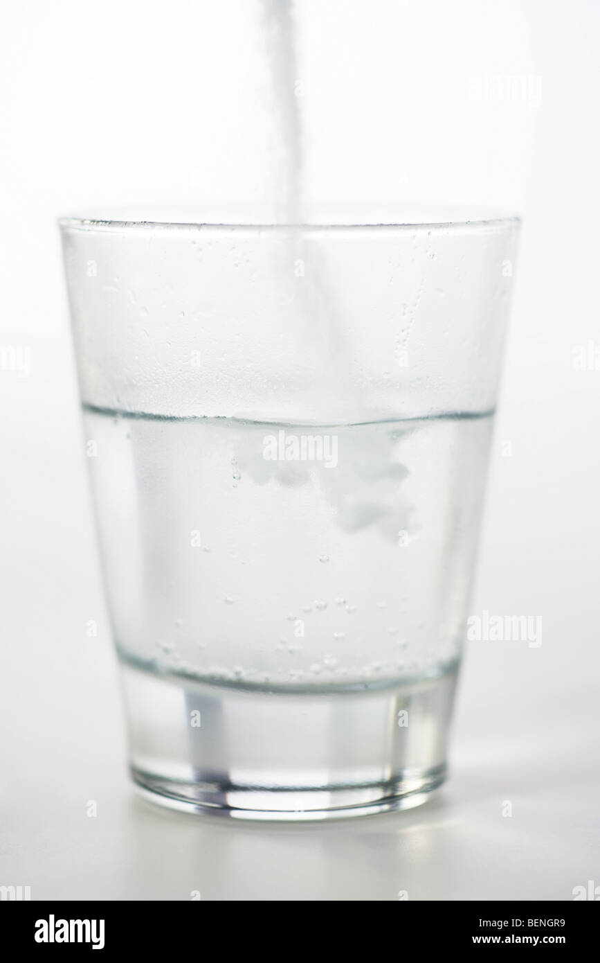 Pouring powdered medicine into glass of water Stock Photo - Alamy