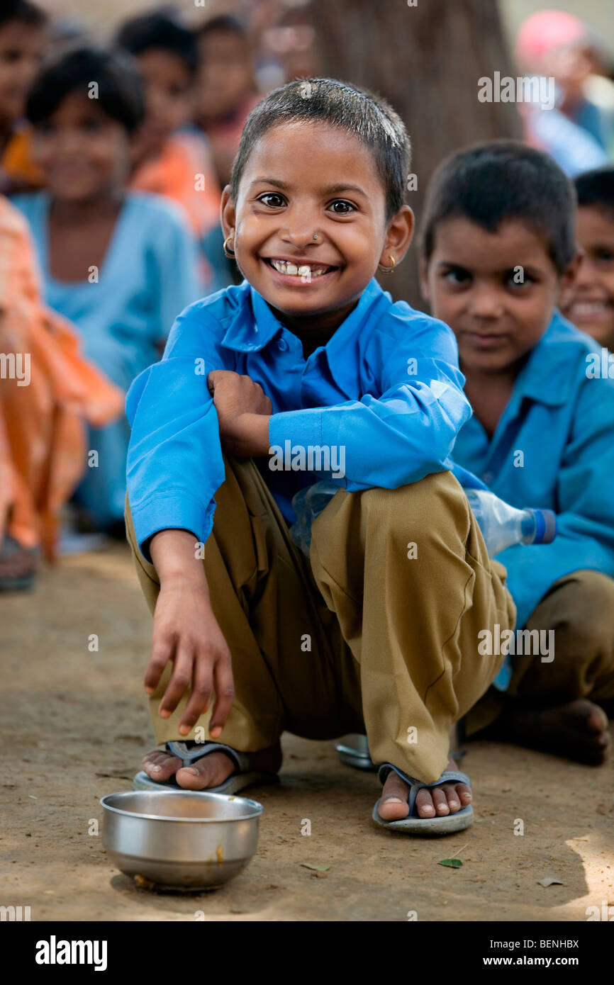 boy waits for his food in an open village school at Mewat near Palwal Haryana India Stock Photo