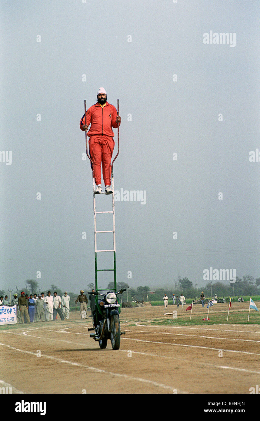 Stuntman performing at rural Olympic games Kila Raipur Punjab India Stock Photo