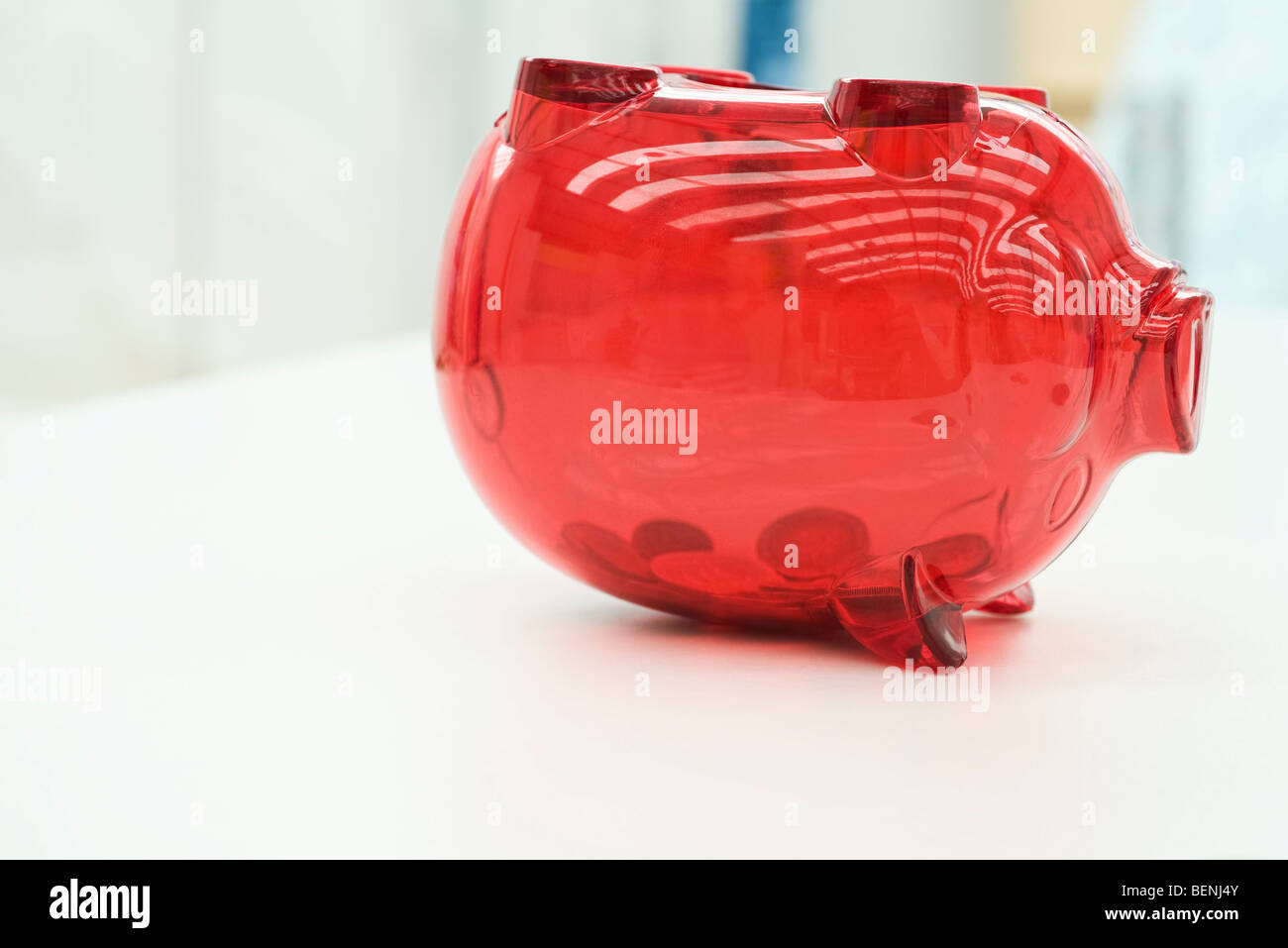 Coins in upside down piggy bank Stock Photo