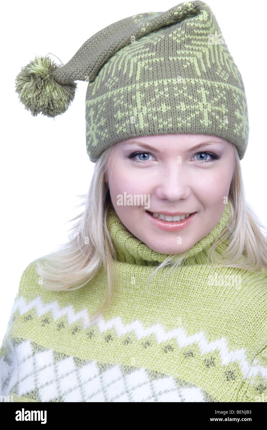 portrait of beautiful smiling blonde girl in green sweater and winter cap with bob Stock Photo