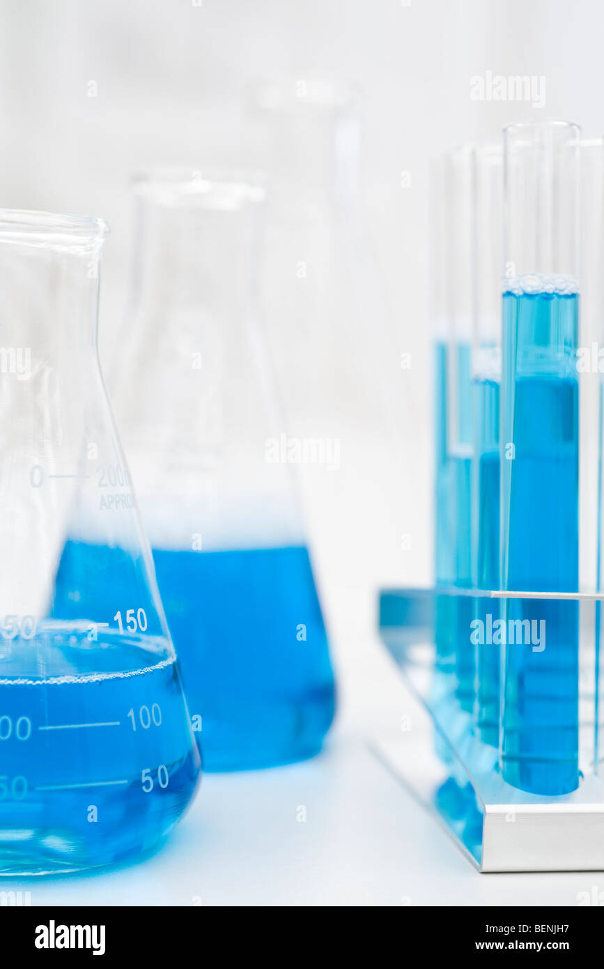 Beakers, test tubes containing blue liquid Stock Photo
