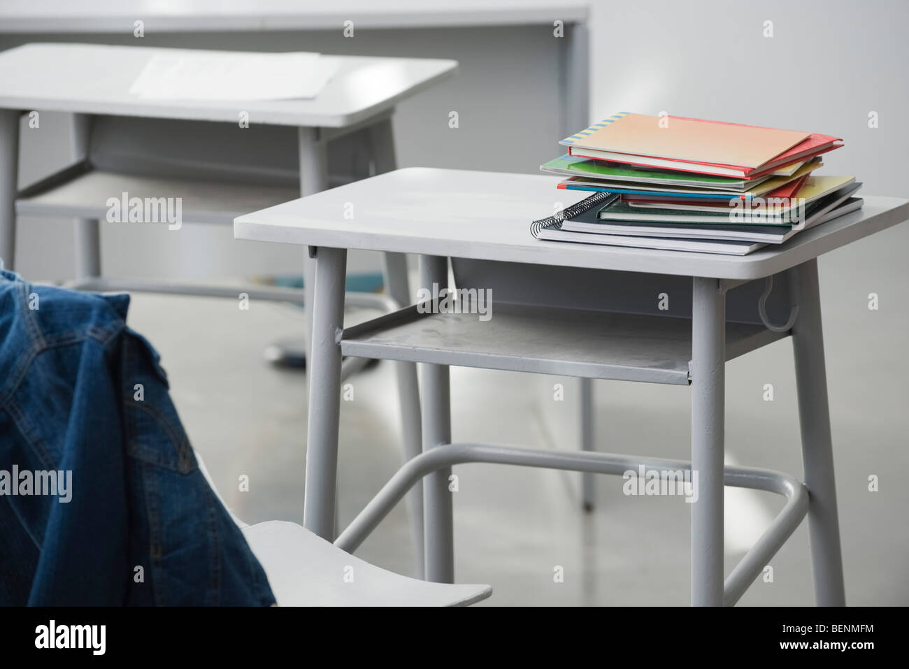 Books stacked on school desk Stock Photo