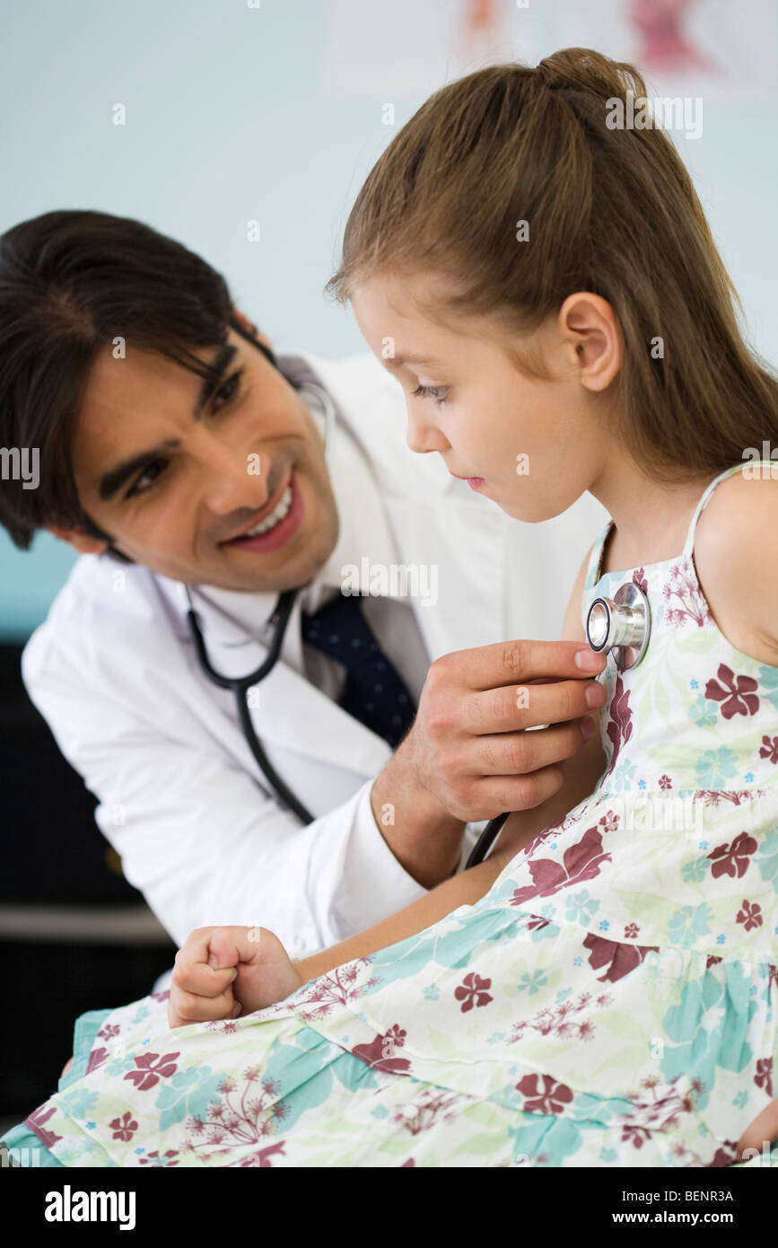 Pediatrician listening to little girl's chest with stethoscope Stock Photo