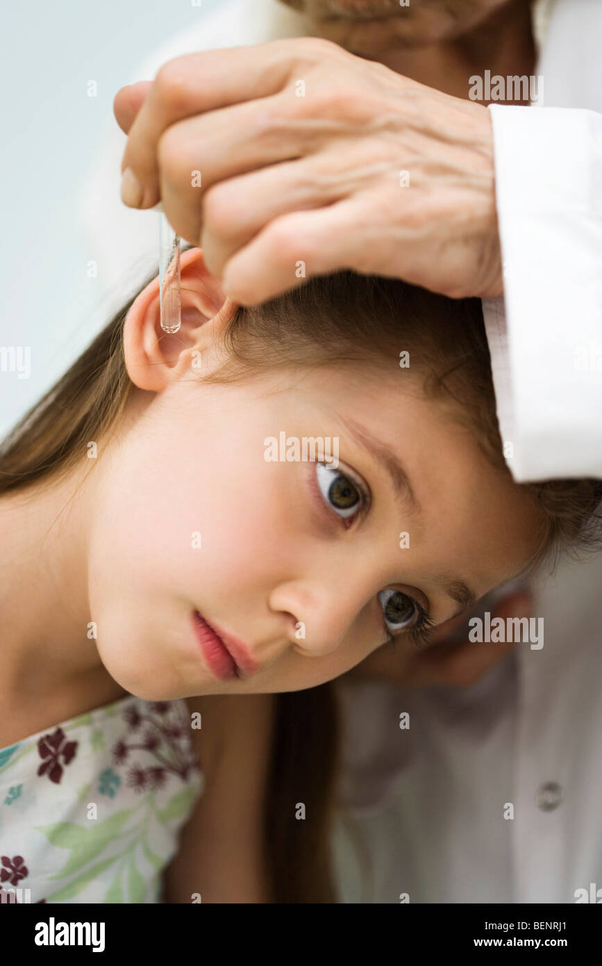 Doctor putting drops in little girl's ear, cropped Stock Photo Alamy