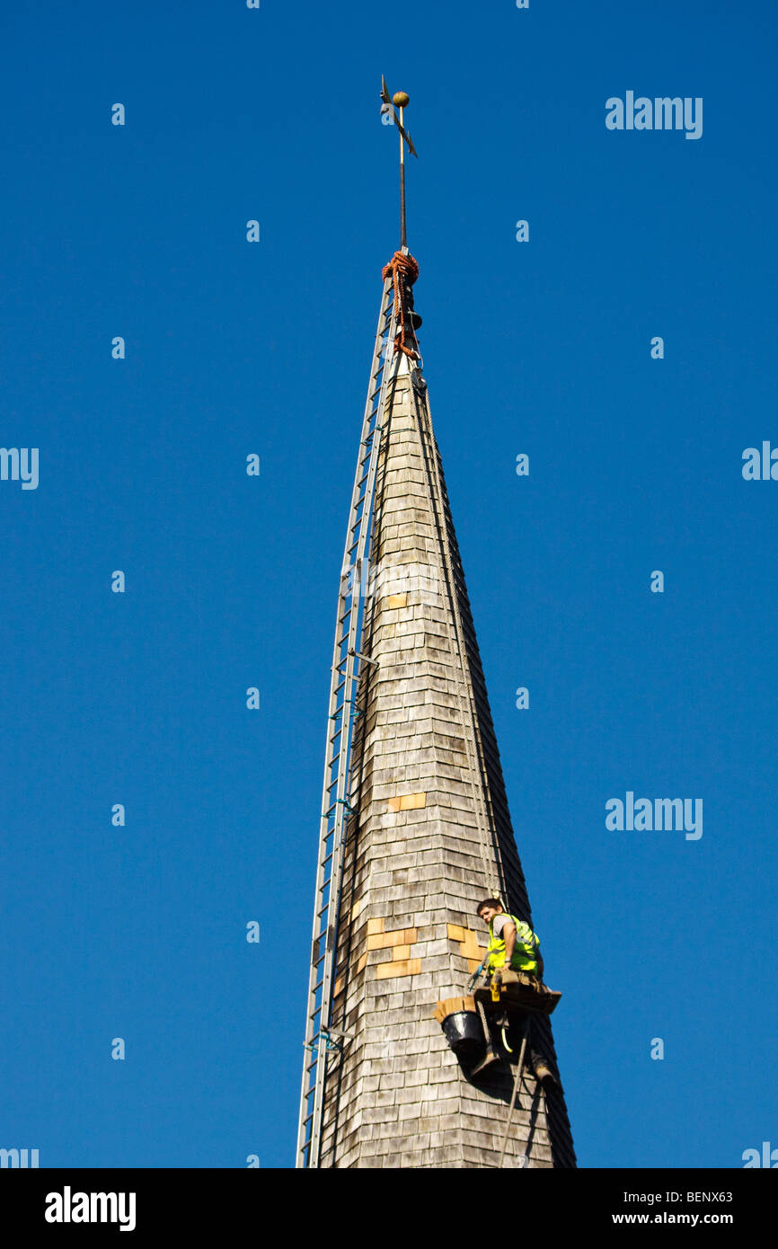 Steeplejack working on the church roof at Horsted Keynes Stock Photo