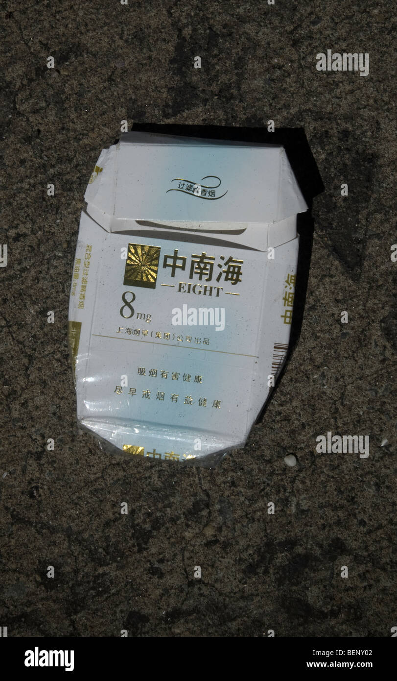 An empty pack of Eight cigarettes is tossed away on the street Stock Photo