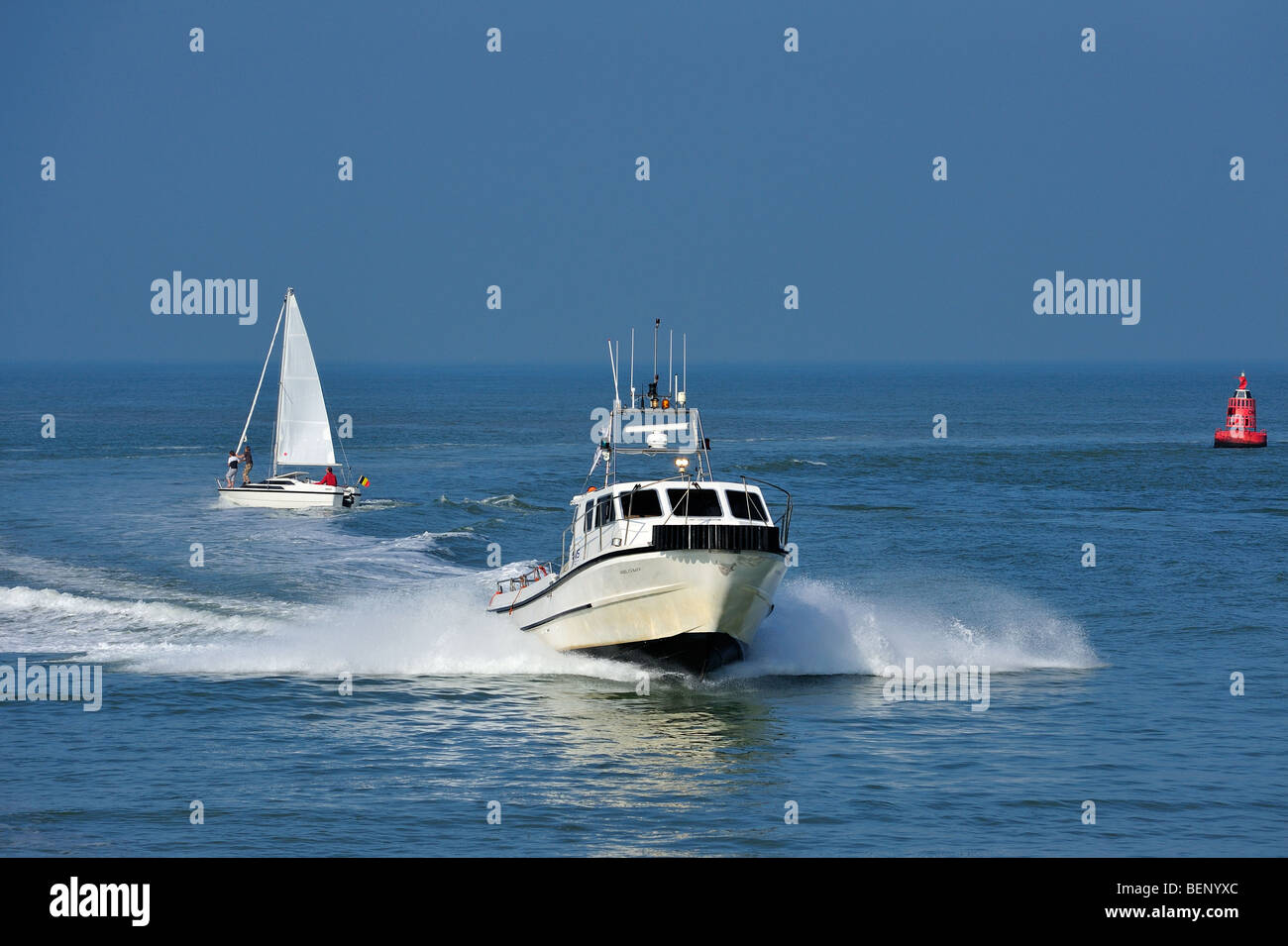 Motorboat / cabin cruiser and sailing boat on the North Sea Stock Photo