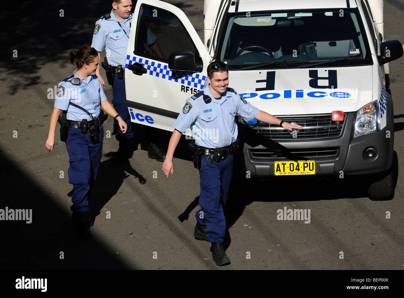 Cheerful police return to their vehicles after making an arrest. Stock Photo