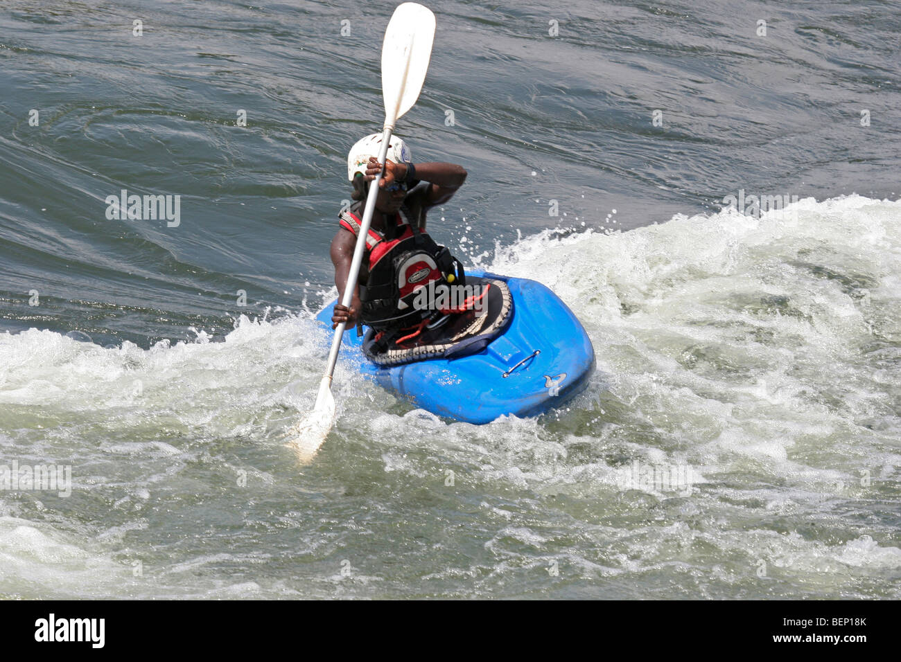 Kayaker in kayak on the river White Nile / Victoria Nile, Uganda