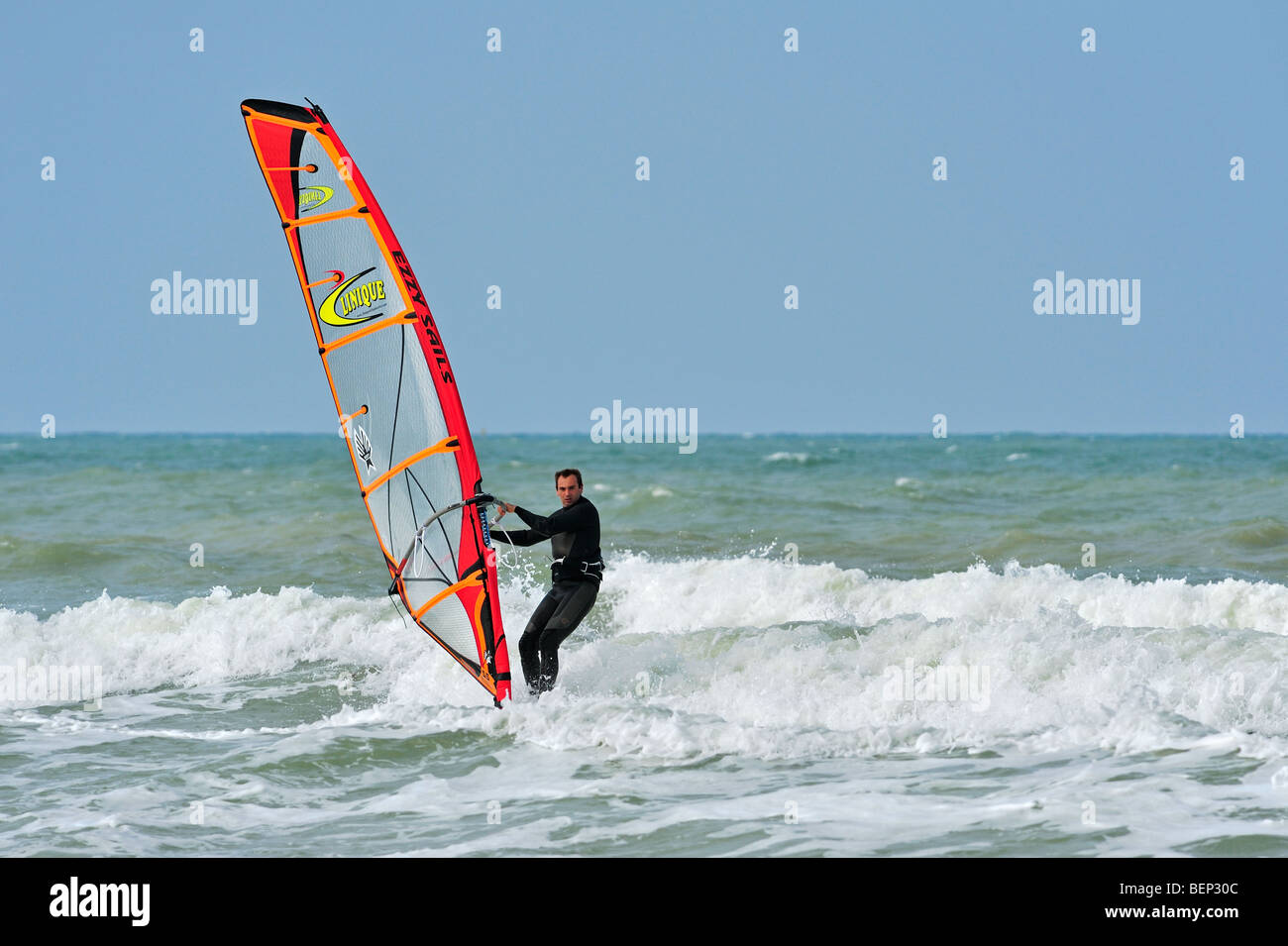 Windsurfer in wetsuit windsurfing on the North Sea Stock Photo