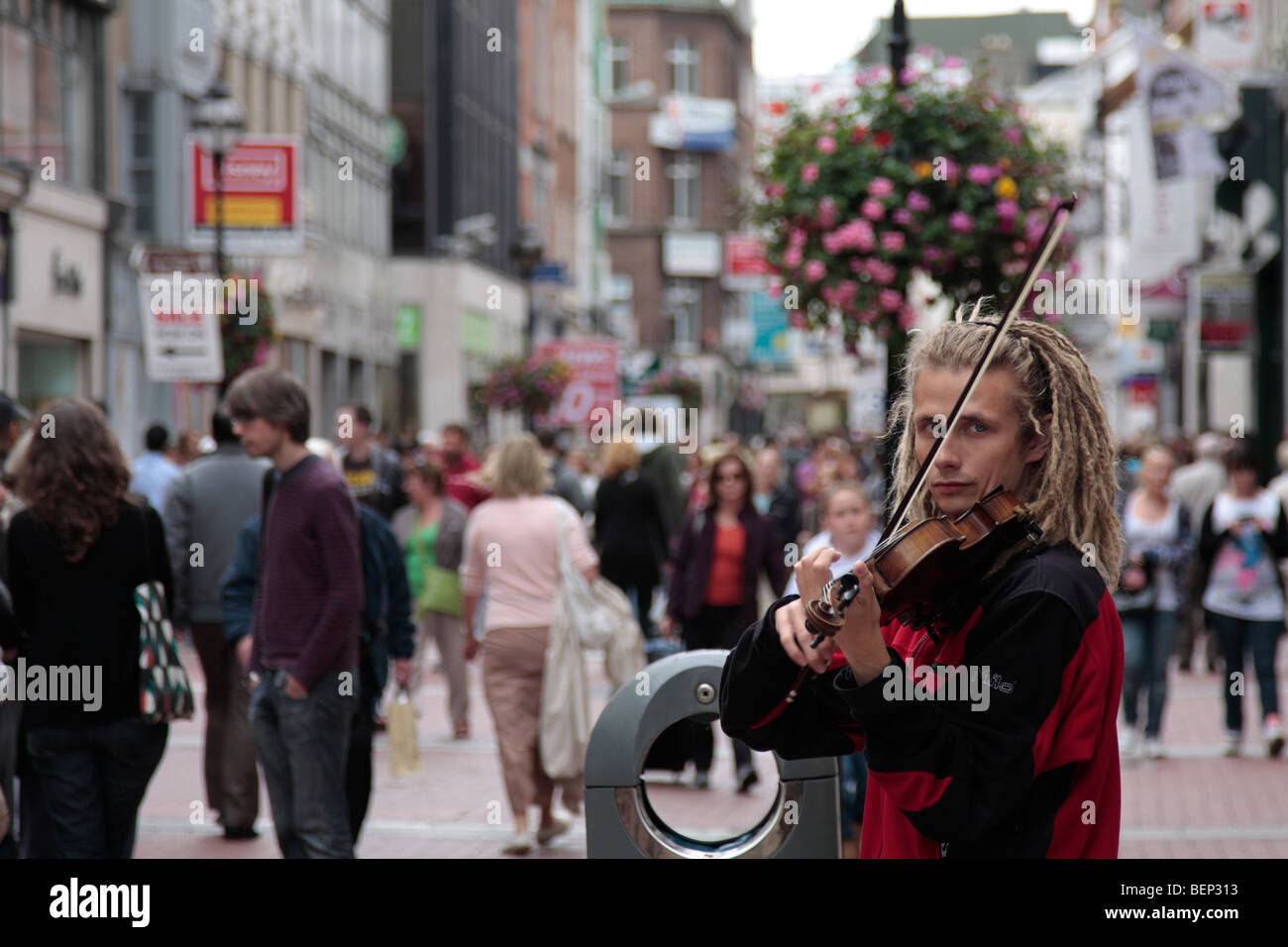 A busker plays the fiddle on Grafton Street in Dublins city centre