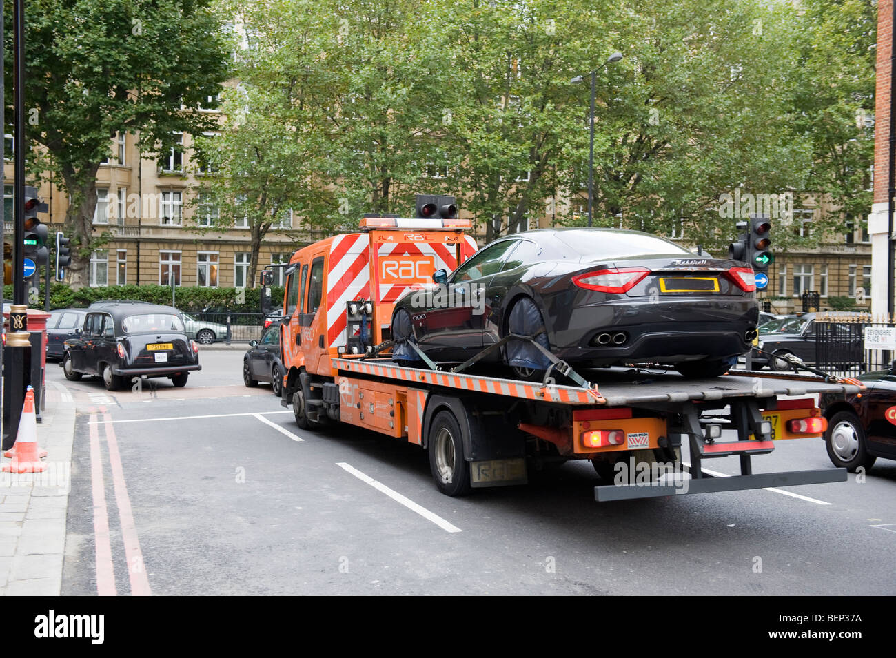 MASERATI SPORTS CAR ON A BREAKDOWN TRUCK, CENTRAL LONDON. Stock Photo
