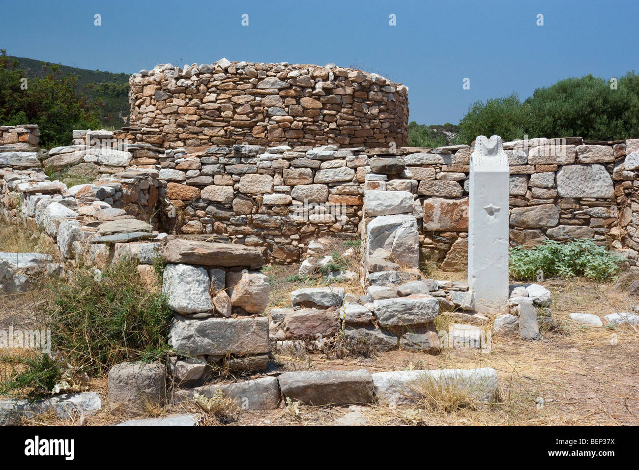 A herm stands in situ in the residential area of Rhamnous, Greece. Stock Photo
