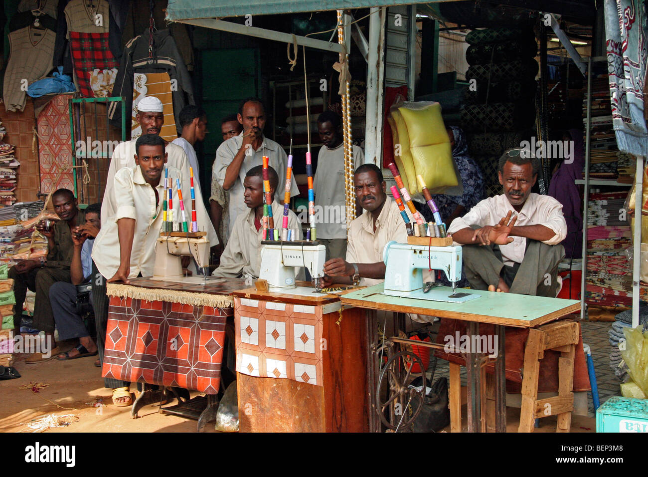 Men behind old treadle sewing machines in sewing in Omdurman