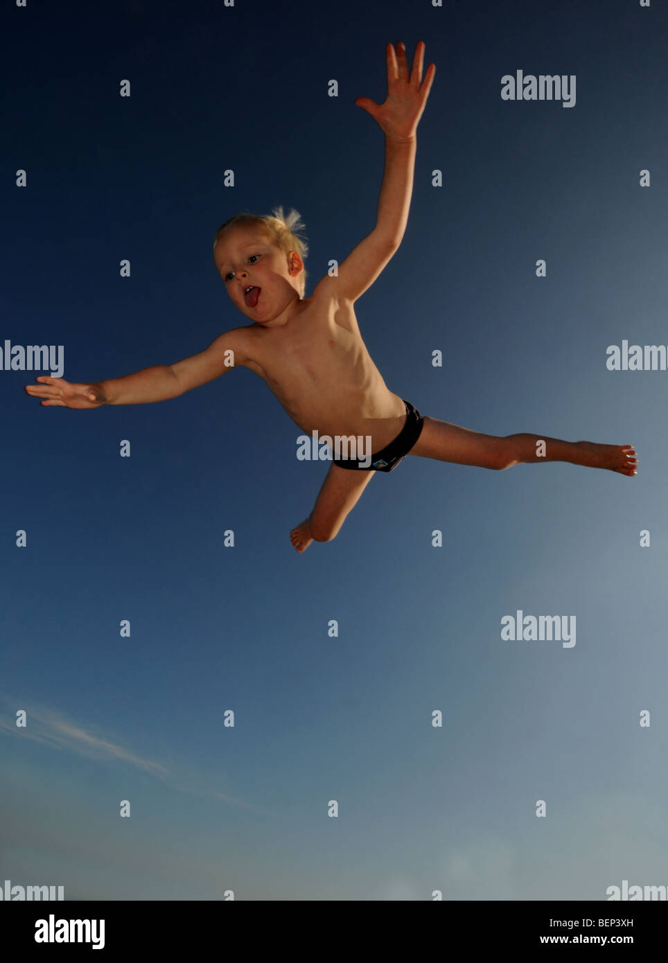 Child being thrown into air playing with his father Stock Photo Alamy