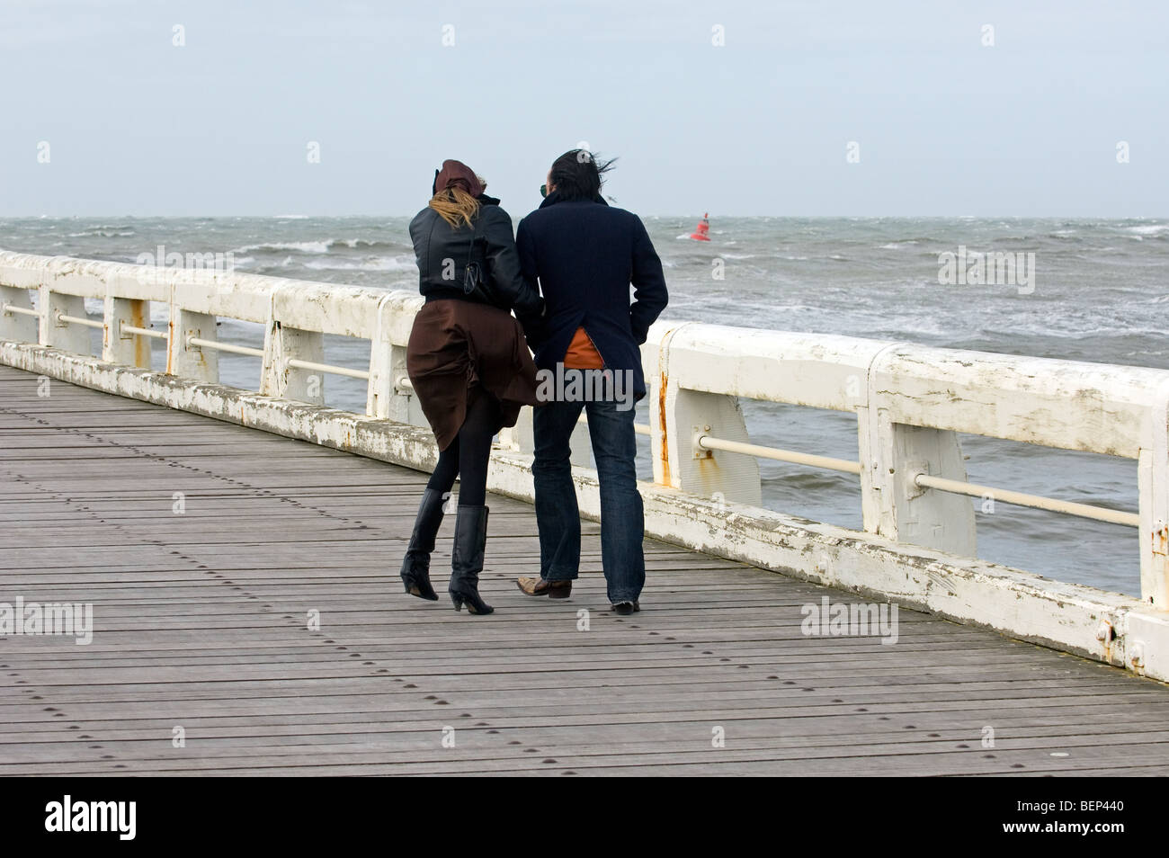 Couple walking jetty storm hi-res stock photography and images - Alamy