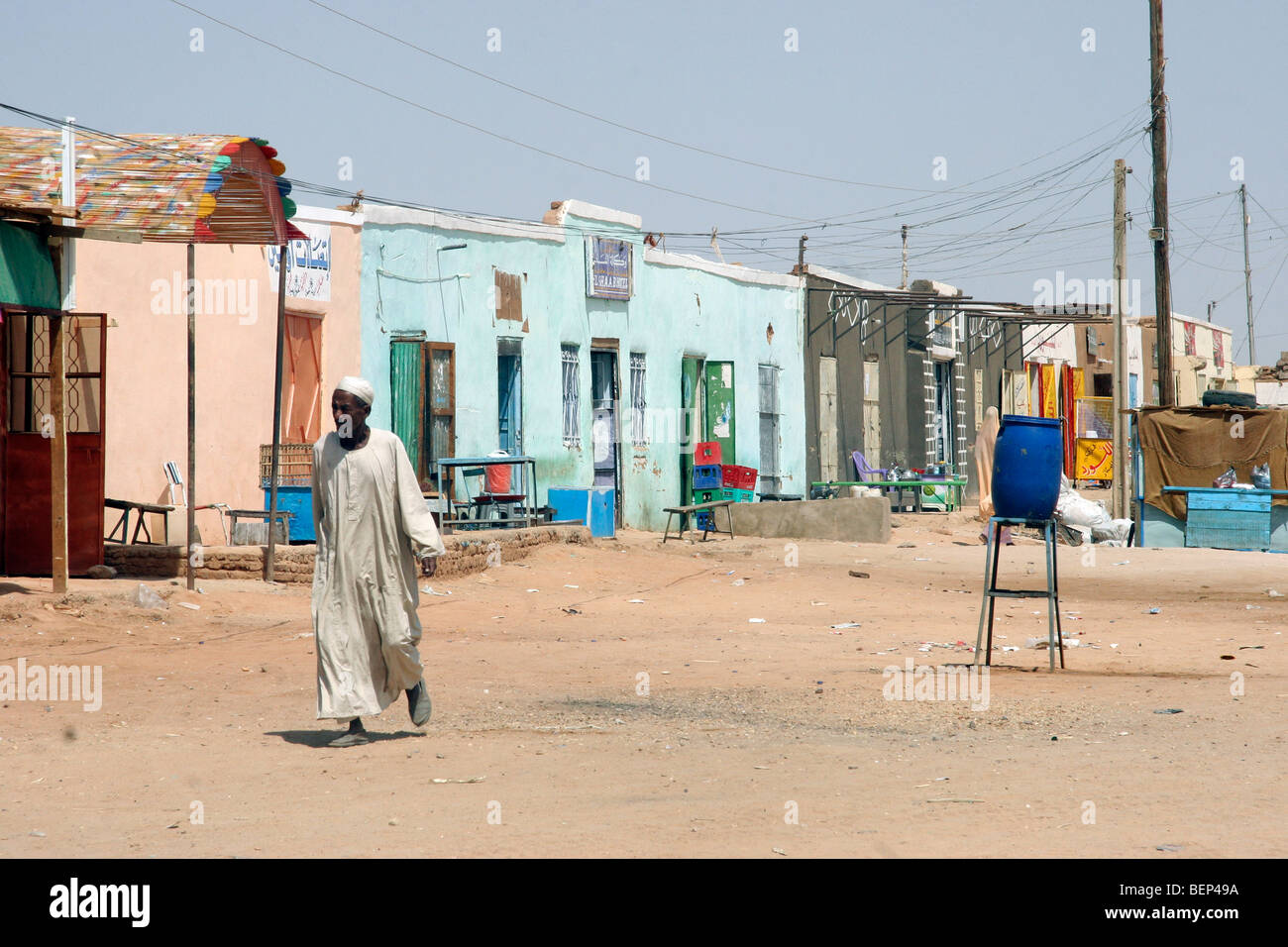 Nubian man dressed in thawb / thobe / dishdasha walking in street at Wadi Halfa, Sudan, North Africa Stock Photo