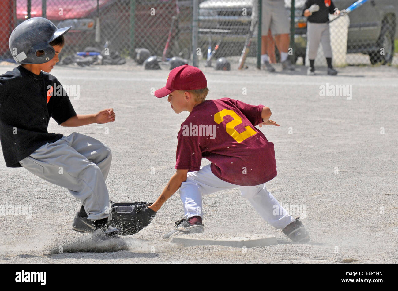 Little league baseball action with 8 and 9 year old players Stock Photo