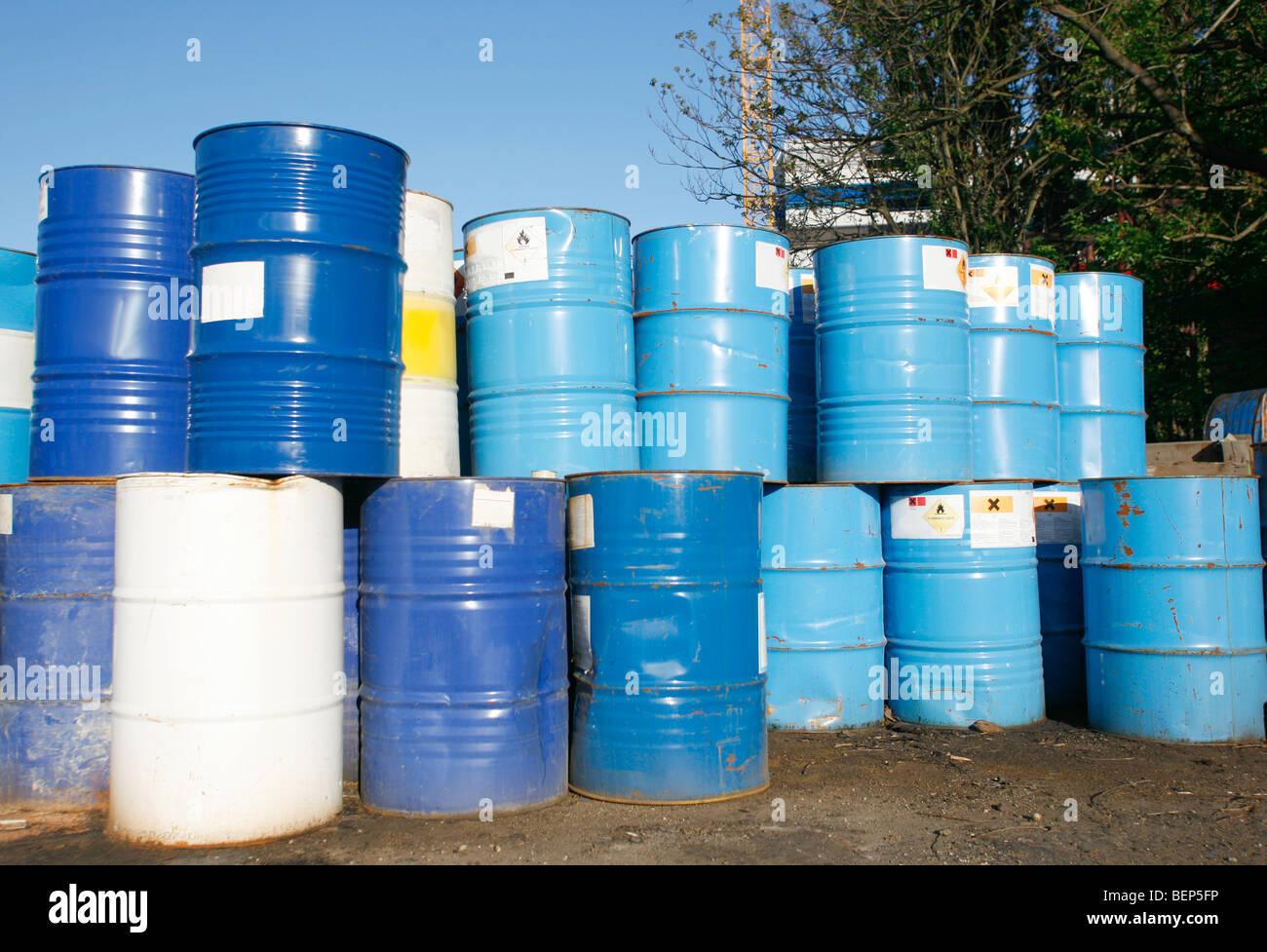 Blue and white oil barrel container drums in junk yard Stock Photo Alamy