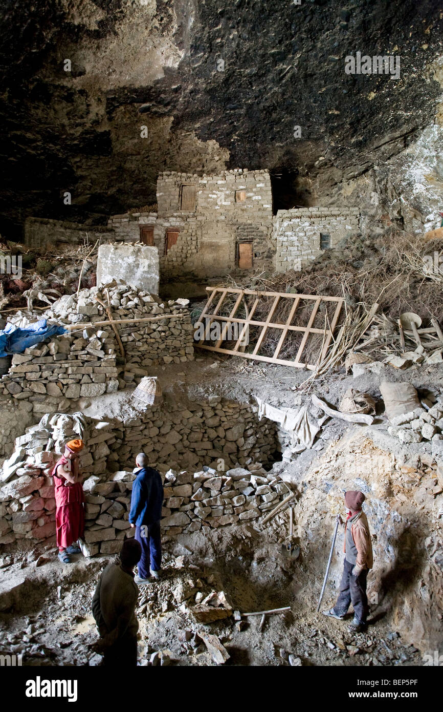 Buddhist monk and workers. Sacred cave. Phuktal monastery. Zanskar. India Stock Photo