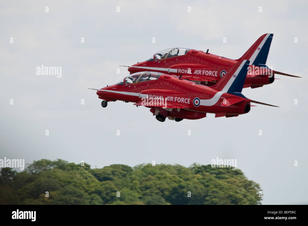 Red Arrows formation team take off in pairs at RAF Waddington Airshow. The Red Arrows currently fly the BAE Hawk aircraft. Stock Photo