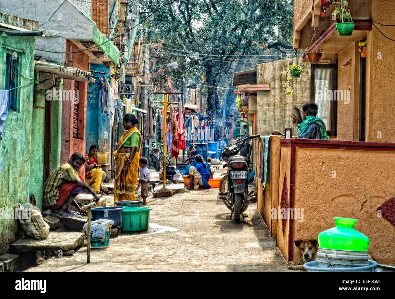 narrow street in Bangalore India  wit residents going about daily tasks Stock Photo