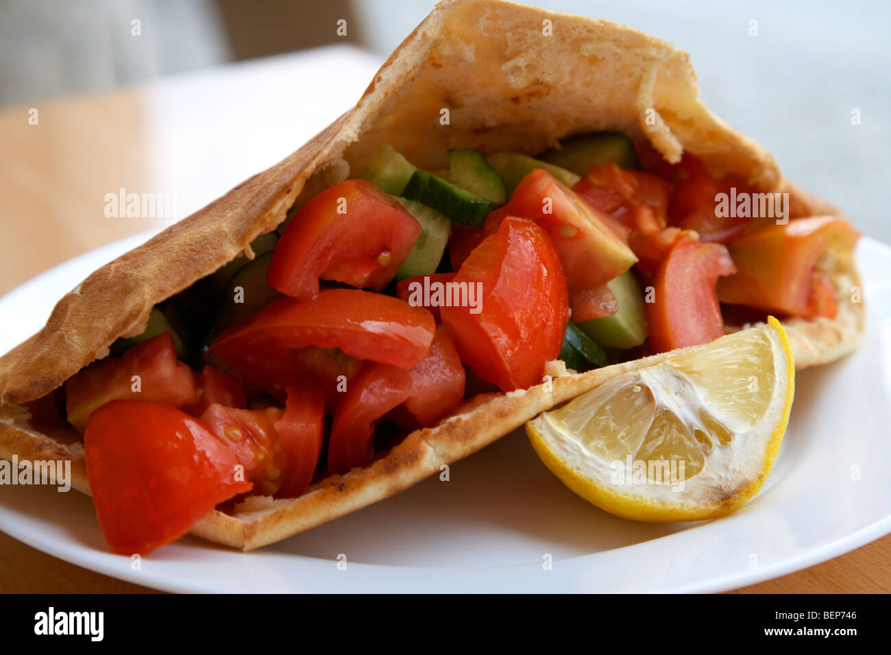 greek vegetarian mediterranean salad in pita bread on a plate in a cafe