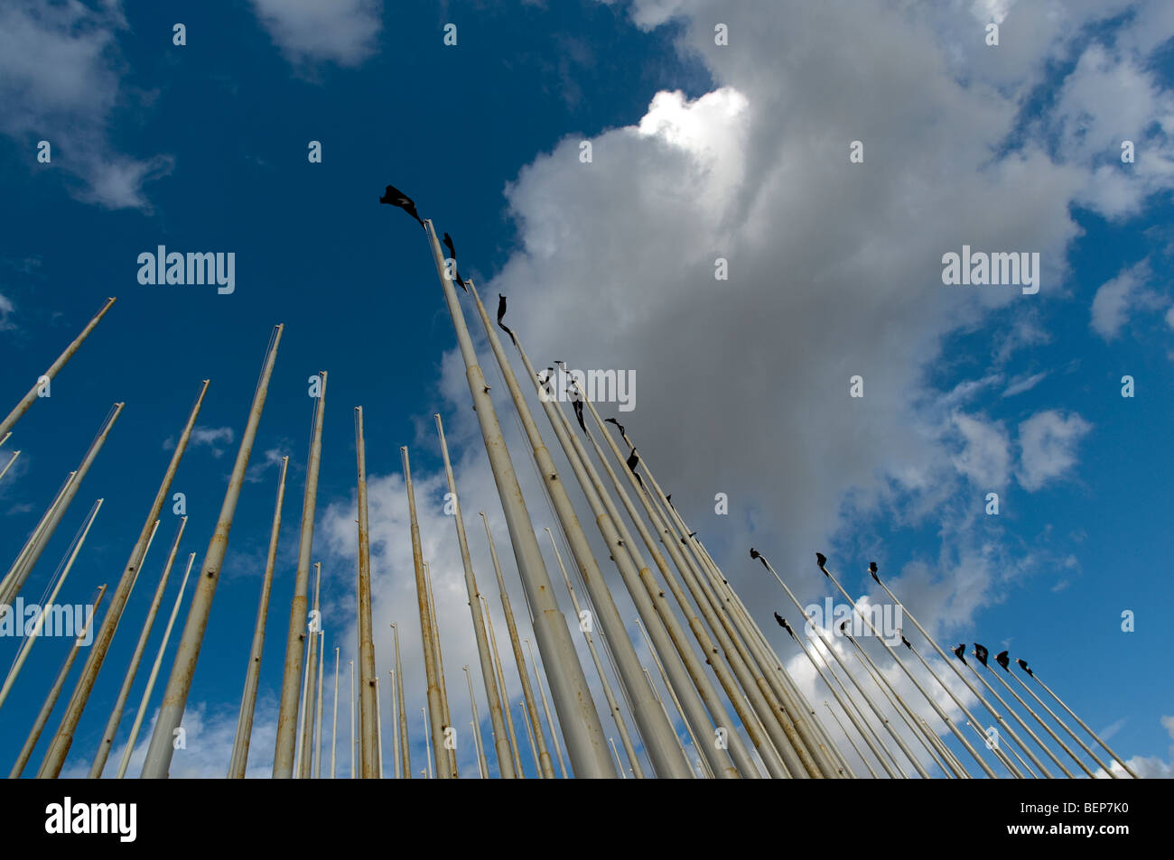 Flagpoles against a blue, but cloudy, sky outside the US Embassy in Havana, Cuba. Stock Photo