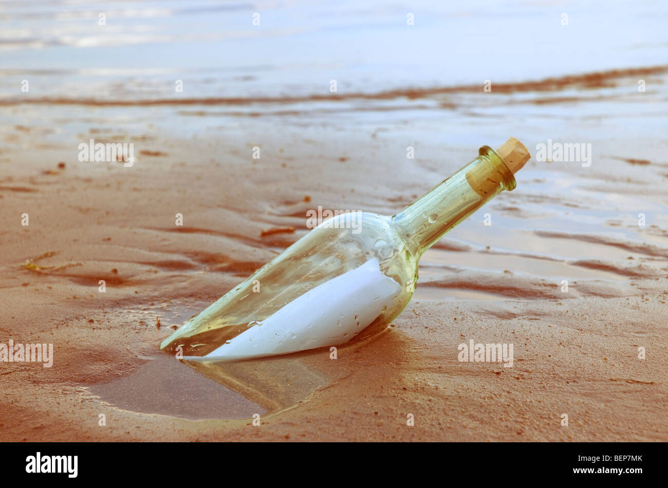 Bottle with a message washed up on a beach Stock Photo