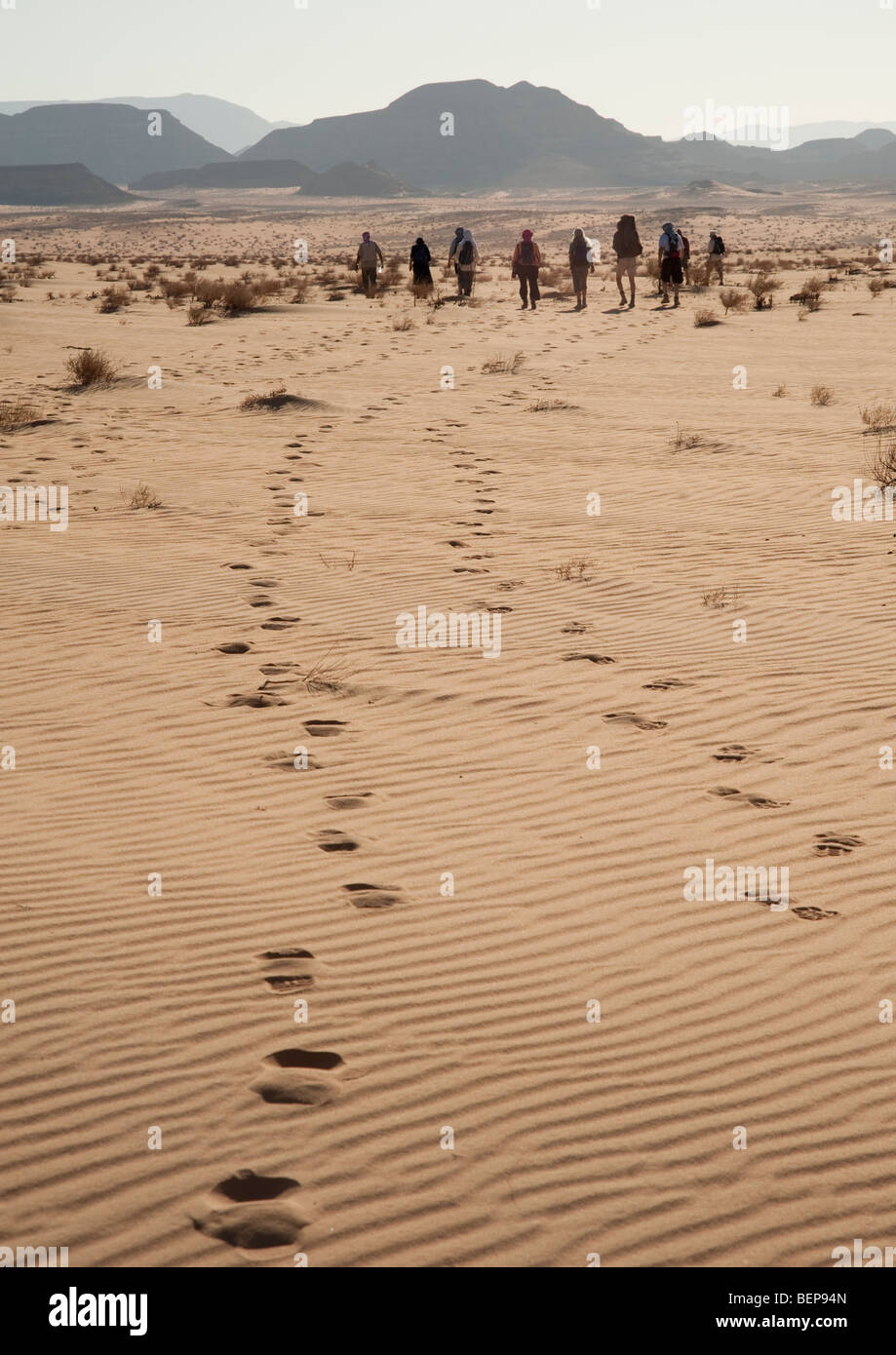 A group of people walking in the desert Stock Photo