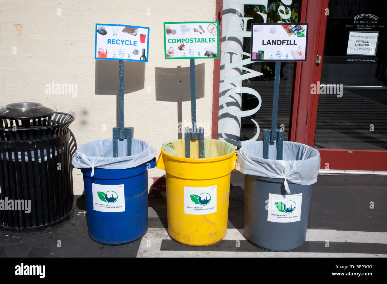 Garbage bins for recycling, composting, and landfill waste at a