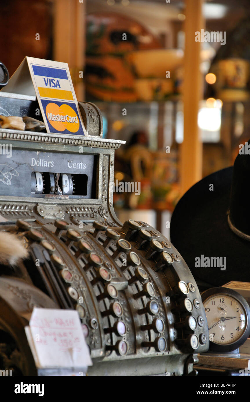 Old cash register at antiques shop with Visa/Mastercard sign on top ...