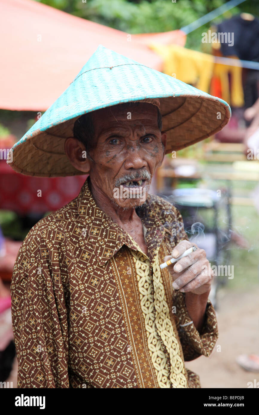 Old man in conical hat, Jawi Duku Padang Indonesia Stock Photo