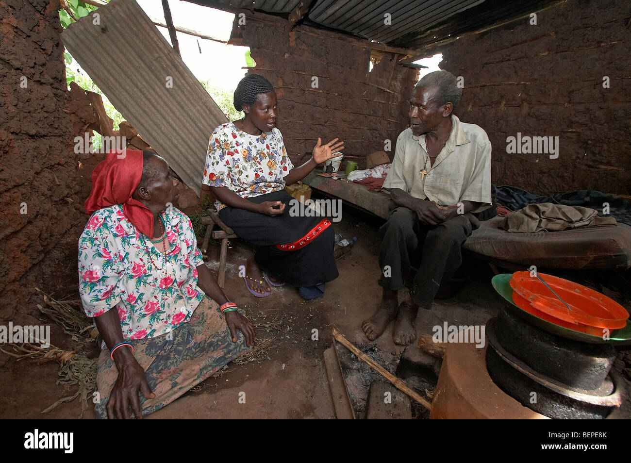 UGANDA Teopista Nejjemba, a 'good Samaritan', visiting Damian Kosolo, who was badly burned in a fire. Kayunga District Stock Photo