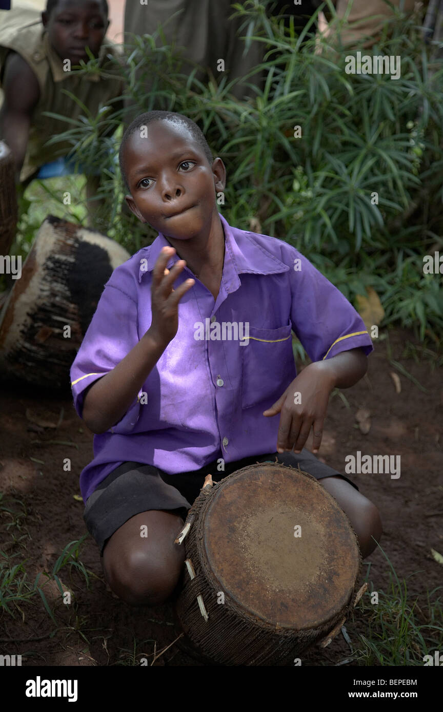 UGANDA The Kyayaaye Roman Catholic primary school in Kayunga District. Young boy playing drum. PHOTO by SEAN SPRAGUE Stock Photo