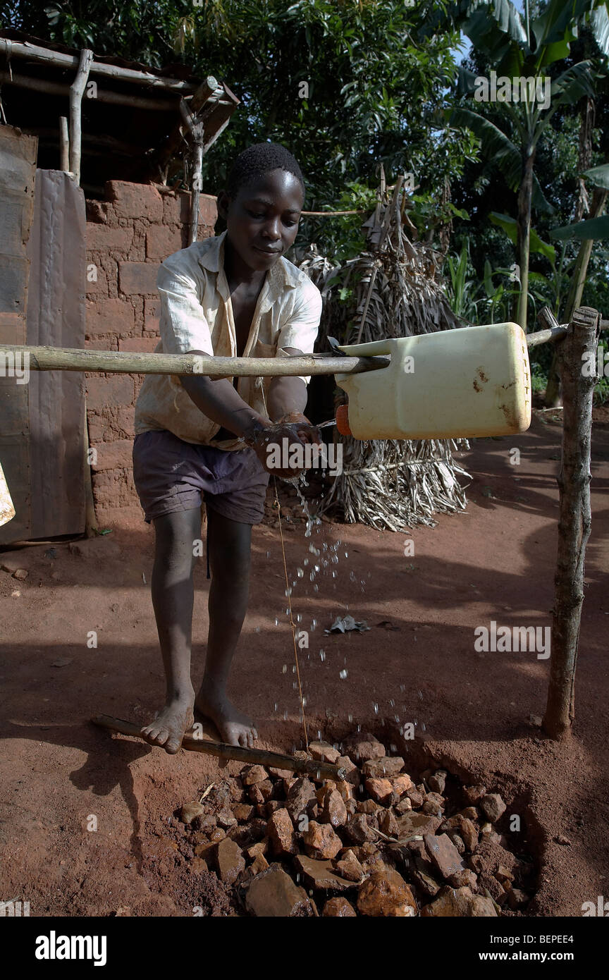 UGANDA Boy washing hands Stock Photo
