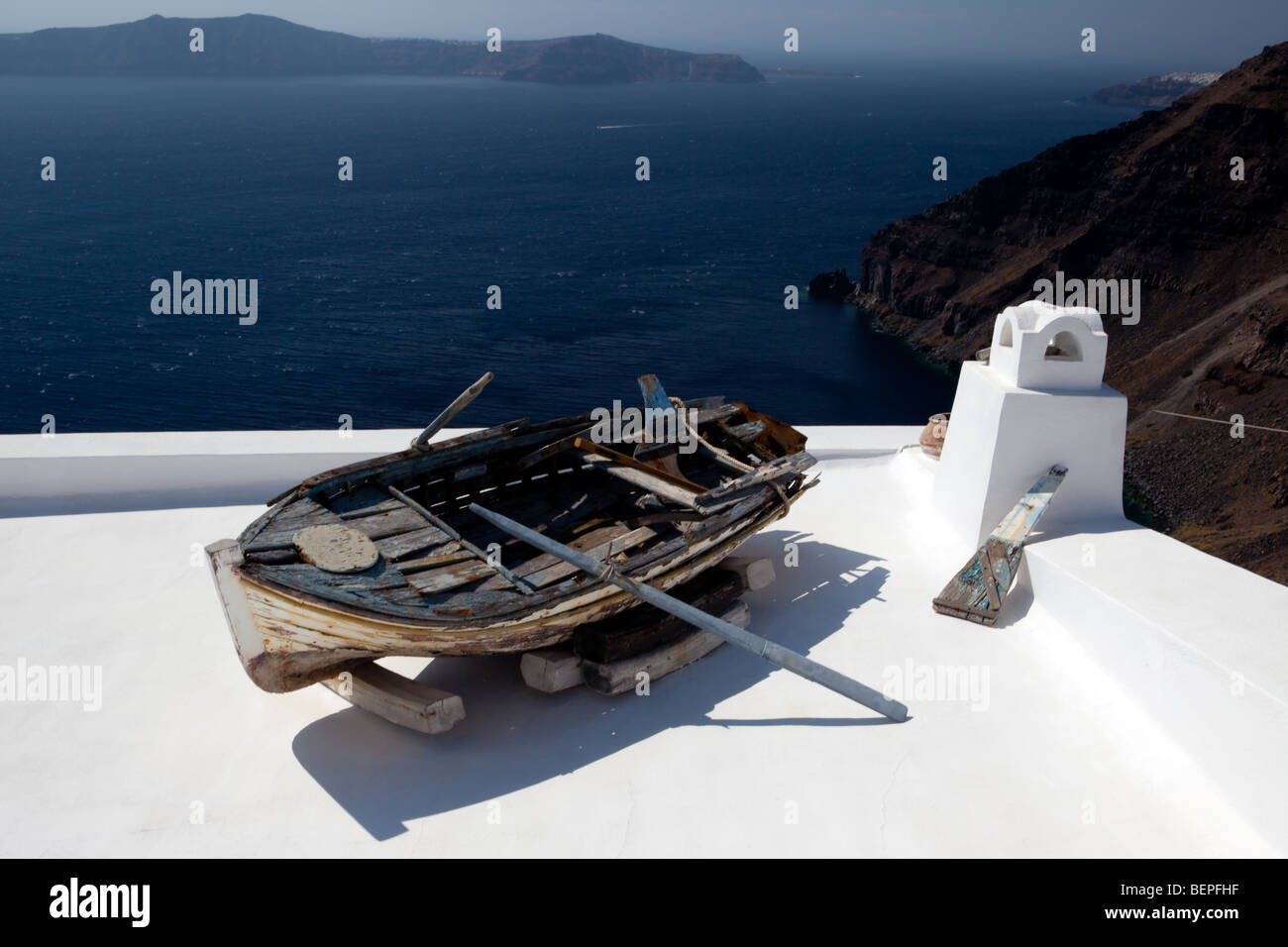 One of sights of island Santorini - an old boat on a roof of one of houses. Stock Photo