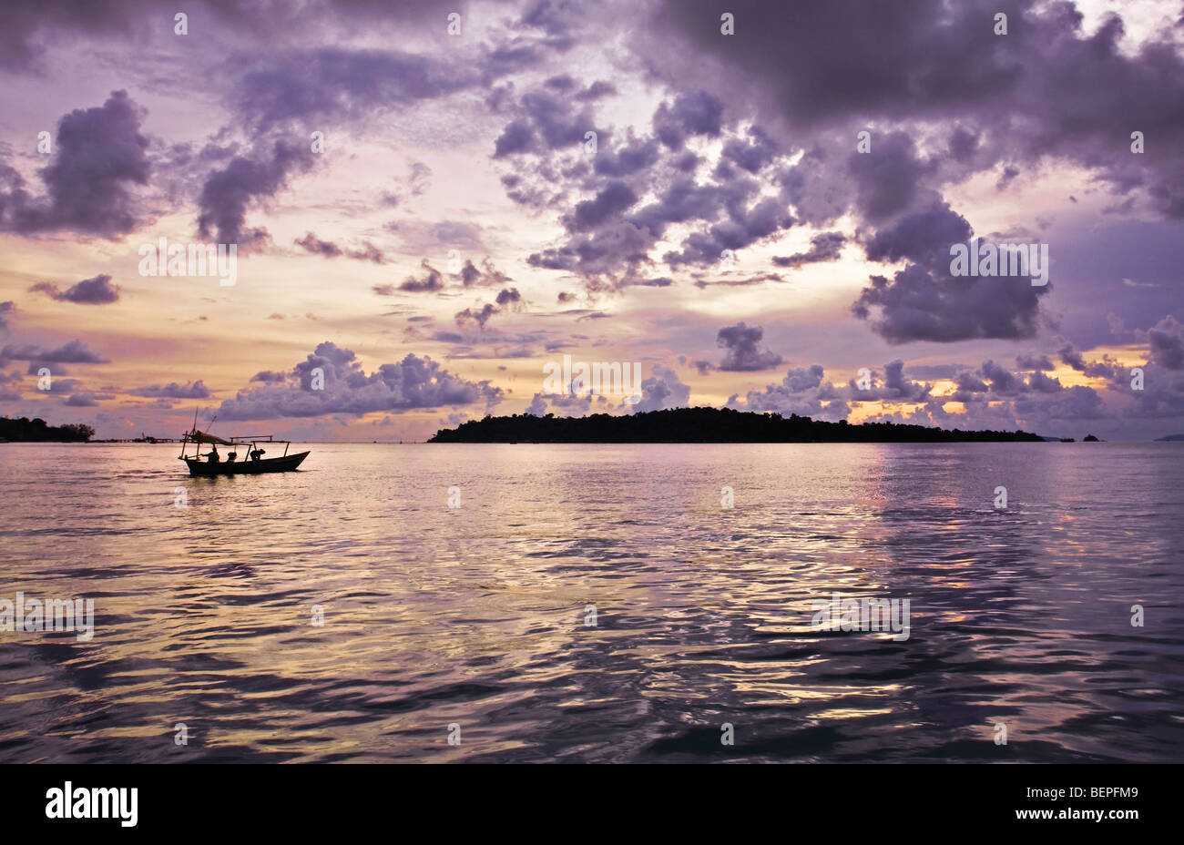 Cambodia Landscape Pink clouds sunset on the South China Sea Bamboo Island Koh Russei and fisherman boat Sihanoukville, Cambodia Stock Photo