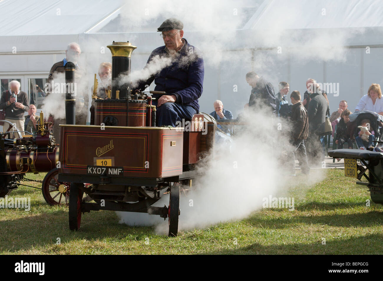 a live steam enthusiast driving his scale model steam lorry Stock Photo