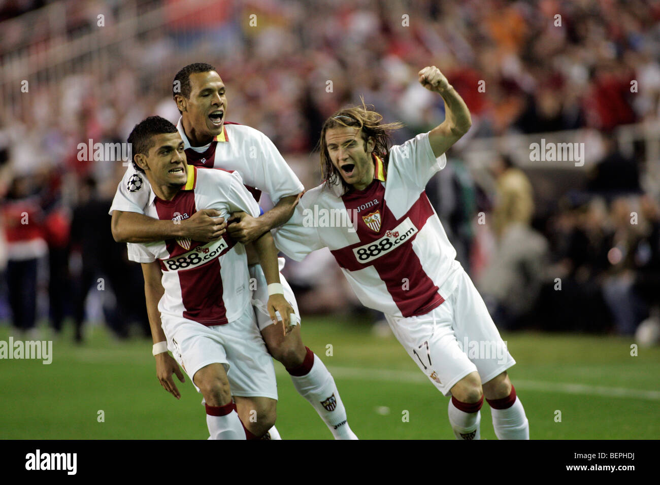 Daniel Alves, Luis Fabiano and Diego Capel celebrating a goal. Stock Photo