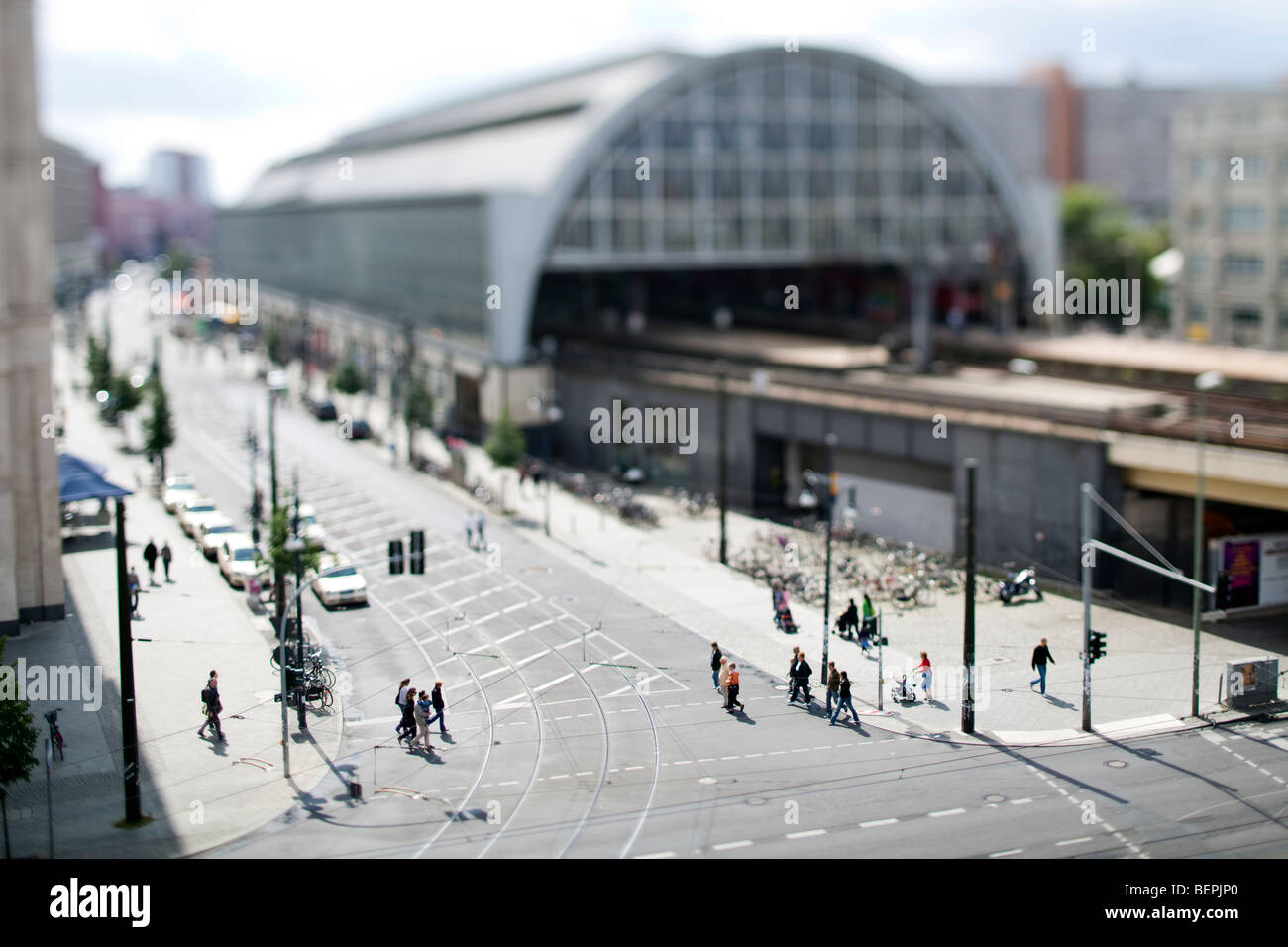 Walkers in front of Alexanderplatz station, Berlin, Germany. Tilted lens used for shallow depth of field. Stock Photo