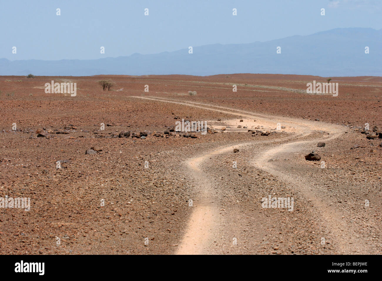 Dirt road through dry plains of northern Kenya, East Africa Stock Photo