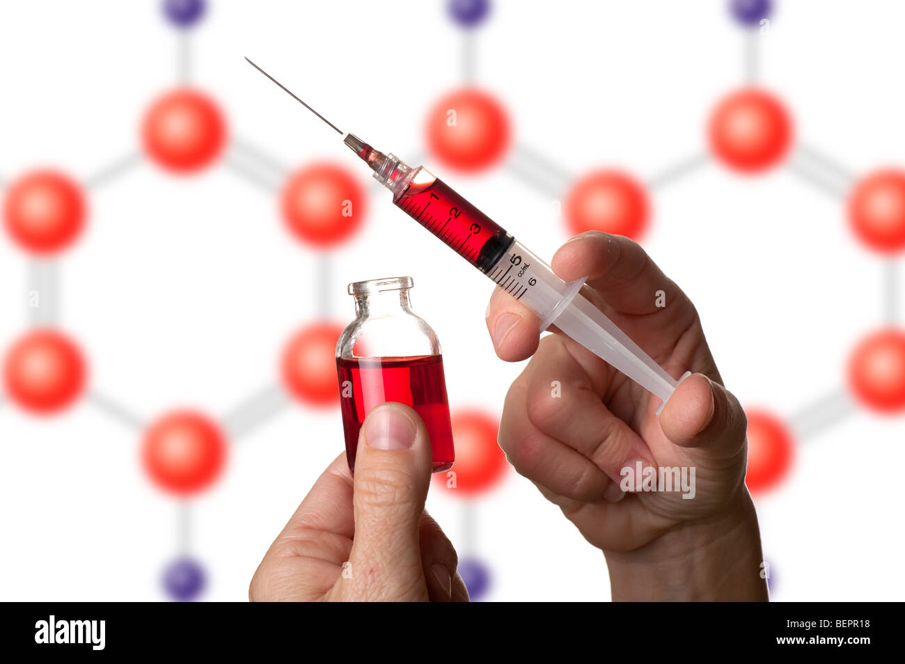 medical doctor holding hypodermic needle and vial Stock Photo