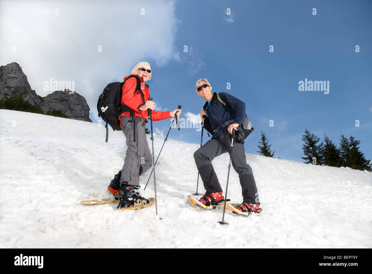 senior couple snowshoeing in mountains Stock Photo